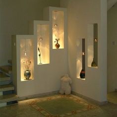 a room with some vases and lights on the wall