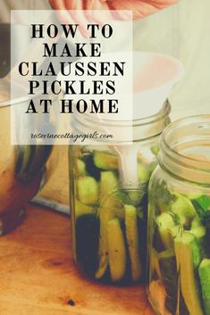 jars filled with pickles sitting on top of a wooden table