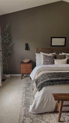 a bedroom with a bed, nightstands and window in it's center area