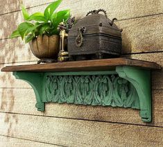 a potted plant sitting on top of a wooden shelf