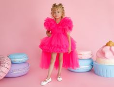 Dress your little girl in the epitome of elegance with our Party Princess Toddler Dress. This enchanting piece combines the charm of a tutu dress with the allure of a party-ready outfit. Crafted in vibrant pink, this dress features a short front hemline and a long trailing back adorned with cascading layers of tulle ruffles. The voluminous short sleeves add a touch of regal splendor, making her feel like a true princess.  Light as a feather, this dress ensures comfort throughout her special occa Pink Princess Dress With Fitted Bodice For Party, Elegant Party Tutu Dress With Fitted Bodice, Pink Tutu Dress For Fancy Dress Party Season, Pink Tutu Dress For Party Season Fancy Dress, Princess Style Fitted Tutu Dress For Evening, Princess Style Fitted Tutu Evening Dress, Fitted Princess Style Tutu Dress For Evening, Princess Style Fitted Evening Tutu Dress, Princess Style Party Evening Dress With Ruffles