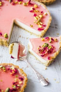 there are several pieces of pie with pink frosting and flowers on top, one slice is missing