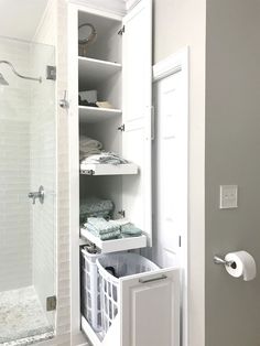 an open closet with towels and other items in it