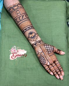 a woman's hand is decorated with hennap and intricate designs on it