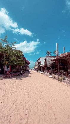 a sandy beach with houses and trees on it