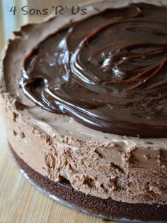 a chocolate cake with frosting on a wooden table