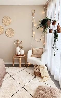 a bedroom decorated in neutrals and whites with lights on the wall