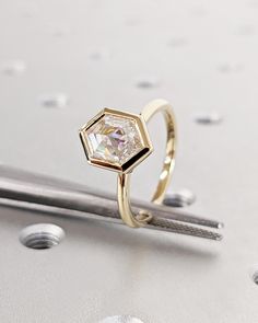 a diamond ring sitting on top of a table