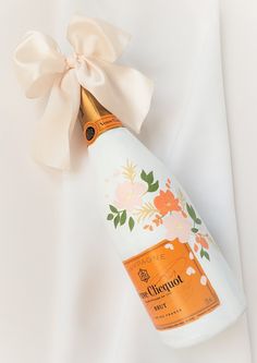 a bottle of champagne with a bow on it