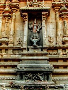 an intricately carved statue on the side of a building