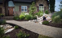 a stone walkway leads to a brick house