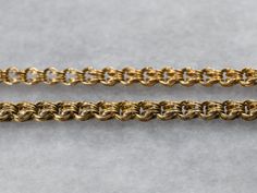 "A breathtaking treasure from the Victorian era, this antique necklace is truly a collector's piece! Dating to the late 1800s or early 1900s, this Victorian necklace was intended for a ladies pendant watch or chatelaine, this chain features a quality of construction that is nearly impossible to find in modern markets. Decorative links weave together to form a single strand. The fobs feature gorgeous black enamel details on the cap, while the tassels are woven wires, with the caps holding them in Victorian Style Metal Necklace With Antique Finish, Victorian 14k Gold Hallmarked Necklace, Victorian Style Antique Finish Metal Necklace, Victorian Antique Finish Gold Necklace, Victorian Antique Gold Nickel-free Necklace, Gold Lariat Necklace, Cameo Ring, Pendant Watches, Enamel Necklaces