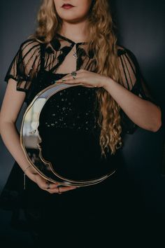 a woman holding a mirror in her hands