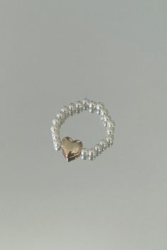 'Pit-a-pat' Ring - a charming addition to your jewelry collection that captures the rhythm of your heart. This delightful ring features a band adorned with pearl beads, offering a touch of sophistication and elegance. At its center rests a dainty metallic puff heart charm, reminiscent of sweet and tender moments. The 'Pit-a-pat' Ring beautifully combines classic pearl beads with a whimsical heart motif, creating a harmonious balance between grace and playfulness.Please handle our beaded chain je Gift Pearl Ring With Pearl Chain Detail, Pearl Rings With Pearl Chain For Gift, Pearl Ring With Pearl Chain As A Gift, Pearl Chain Ring Perfect As A Gift, Pearl White Ring With Pearl Chain, Pearl Chain Ring Jewelry, Adjustable Pearl Charm Ring For Wedding, Adjustable Wedding Ring With Pearl Charm, Adjustable Pearl Open Ring Jewelry