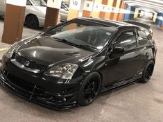 a black car parked in a parking garage