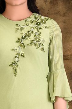 Lemon green long tunic with thread and pearl studded floral applique work.
Components:1
Embroidered
Neckline:Round
Sleeve Length:Three quarters
Fabric:Viscose georgette
Color:Green
Back keyhole with loop button
Pintuck bell sleeves
Cowl draping
Asymmetric hem - Aza Fashions Eid Embellished Pista Green Kurta, Spring Pista Green Kurta With Mirror Work, Green Embellished Straight Kurta Dress, Hand Embellished Georgette Dresses For Summer, Elegant Green Kurta With Floral Embroidery, Elegant Green Tops For Eid, Embellished Georgette Kurta For Summer, Green Georgette Dresses With Floral Embroidery, Spring Georgette Tops With Floral Embroidery