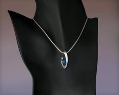 "London Blue Topaz and White Sapphire Necklace - Argentium Silver - 3418 - Argentium chain Included Make a statement with this contemporary design handcrafted by award winning designer, David Worcester. ( IMPORTANT - PLEASE READ 1. AND 2 BELOW ) 1.) INCLUDED IN THE PRICE IS AN ARGENTIUM SILVER CHAIN APPROPRIATE FOR THE PENDANT CHOSEN. YOU CAN CHOOSE FROM 16\", 18\" OR 20\" AT CHECKOUT. 2.) PLEASE LOOK AT THE MEASUREMENTS CAREFULLY. SOME PHOTOS HAVE BEEN ENLARGED TO SHOW DETAIL, WHILE OTHERS HAVE Modern Blue Topaz Gemstone Necklaces, Modern Silver Jewelry With Birthstone, Modern Blue Topaz Gemstone Necklace, Formal Blue Topaz Oval Pendant Necklace, Contemporary Sterling Silver Jewelry For Wedding, Contemporary Sterling Silver Wedding Jewelry, Blue Topaz Oval Pendant Necklace For Anniversary, Modern Sterling Silver Necklace With Brilliant Cut, Modern Sterling Silver Necklace With Diamond Cut