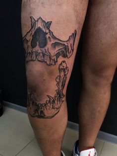 a man's leg with a skull tattoo on it