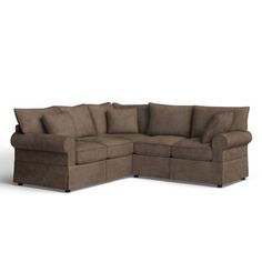 a brown sectional couch with pillows on it's back and the seat facing outward