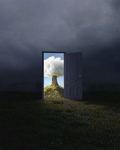 an open door with a view of a mountain in the sky and clouds behind it