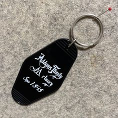 a black keychain with the words harry potter on it