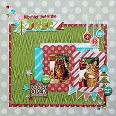 a scrapbook page with two cats on it and christmas decorations around the edges,