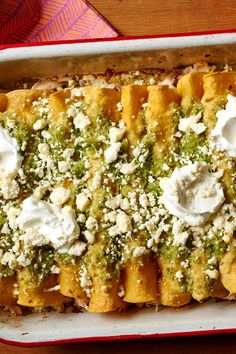 a casserole dish with broccoli, cheese and sour cream on top