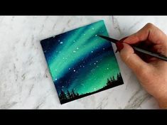 someone is painting an aurora bore in the sky