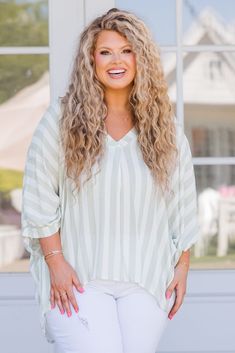 Get your summer style on point with this top in green! The high-low hemline and vertical stripes give a fun and playful vibe, while the three-quarter dolman sleeves keep you cool and comfy! Made from lightweight and airy fabric, this top is the perfect staple for your summer wardrobe! 100% Rayon Oversized Striped Beach Top, Oversized 3/4 Sleeve Beach Tops, Green 3/4 Sleeve Blouse For Vacation, Spring Green Batwing Sleeve Tops, Green Batwing Sleeve Tops For Spring, Spring Green Batwing Sleeve Blouse, Spring Green Blouse With Batwing Sleeves, Oversized Striped Tops For Vacation, Green Batwing Sleeve Blouse For Spring