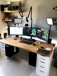 a desk with two computer monitors on top of it