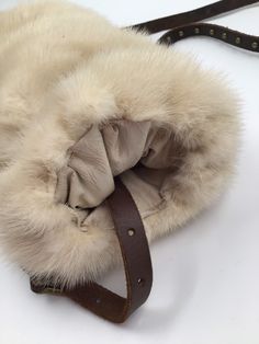 "Light beige women's muff, made from real mink fur, soft and velvet fur with long pile, comfort muff, warm muff, cinema style muff, Red carpet muff, wedding muff, party muff, bride muff, theatre muff, show muff, vintage style, retro style, has size medium. Women's fashionable muff; made from real mink fur; fur is soft and genuine, with shiny long pile; warm, broad, comfortable muff - light beige color. Fashionable muff, perfectly representing the function of warming and decoration; has leather b Cream Fur Coat With Faux Fur Lining, Cream Faux Fur Coat With Faux Fur Lining, Mink Sheepskin Fur Coat With Faux Fur Lining, Mink Colored Sheepskin Fur Coat With Faux Fur Lining, Mink Color Sheepskin Fur Coat With Faux Fur Lining, Cream Sheepskin Fur Coat With Faux Fur Trim, Fluffy Beige Faux Fur Coat, Cream Faux Fur Coat, Cowboy Jacket