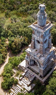 an aerial view of a tower in the middle of trees