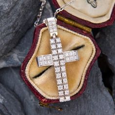 This geometric cross pendant is accented with forty (40) prong set round brilliant cut diamonds. The pendant, including the bail, measures 33.2mm X 16.9mm X 5.1mm. The pendant is suspended from a white gold cable chain that is 0.9mm wide, 15.5 inches long, and is finished with a spring ring clasp. Luxury Cross-shaped Diamond Cut Necklace, Luxury White Gold Cross Necklace, Luxury Diamond White Cross Pendant Necklace, Luxury White Gold Cross Necklace With Diamond Accents, Luxury Cross Necklace With Diamond Accents, Luxury Pendant Cross Necklace With Diamond Accents, Luxury White Gold Cross Necklace For Formal Occasions, Luxury Cross Necklace For Formal Occasions, Luxury Formal Cross Pendant Necklace