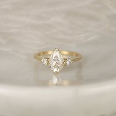 a gold ring with three diamonds on it