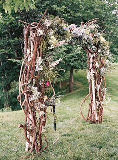 the wedding arch is decorated with flowers and greenery