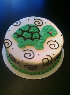 there is a cake with a green turtle on it