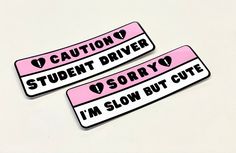 two pink and white stickers that say caution student driver sorry i'm slow but cute