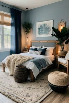 a bedroom with blue walls, white bedding and rugs on the wooden floor