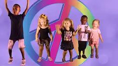 a group of children standing in front of a peace sign