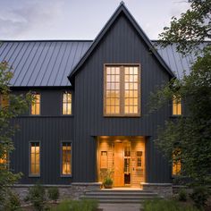 a large house with lots of windows and steps leading up to the front door area