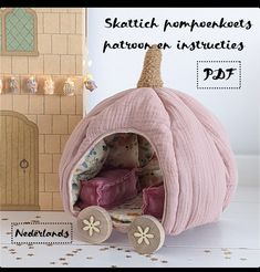 a doll house with a pink pumpkin shaped bed in the shape of a horse drawn carriage