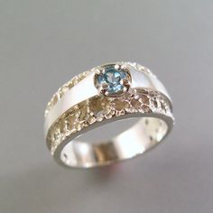 The blue topaz in this piece glows on its satiny silver ribbon set against silver lace. A classic, very feminine ring. The width of the band is 8.5mm on the top, and 4.5mm on the bottom which makes it a very comfortable wear. This ring is a size 7. It can be made in any size needed. If you would like this ring, but prefer a different gem choice, contact me for details. This ring is stunning in 14k yellow gold! Contact me for pricing in 14k. Widow Wedding, Wedding Ring Redesign, Blue Sapphire Eternity Band, Blue Topaz Ring Sterling Silver, Ring Redesign, Topas Ring, Lace Ring, Fine Diamond Jewelry, Buying Diamonds