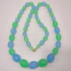 Vintage Gold Tone & Bright Blue and Green Lucite Celluloid Beaded Necklace Not sure of material Celluloid?  Lucite?   Bakelite?  Good vintage shape    Measures about: 32"   unsigned  Gold tone clasp Green Plastic Round Bead Jewelry, Vintage Blue Glass Beaded Necklaces, Blue Beaded Retro Jewelry, Retro Blue Beaded Jewelry, Vintage Blue Glass Beads, Vintage Blue Single Strand Beaded Necklaces, Vintage Blue Single Strand Beaded Necklace, Blue And Green, Bright Blue