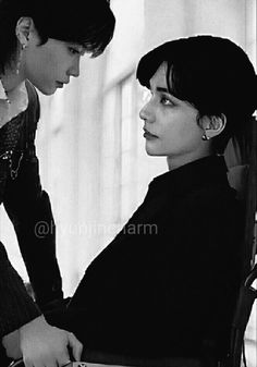 black and white photograph of two women looking at each other