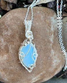 This diamond shaped opalite pendant is wrapped in silver wire and adorned with silver beads and a beautiful swirl on top. Handmade jewelry is one of the best gifts! Opalite is deigned to mimic the October birthstone, natural opal, so this would be the perfect gift for those you know born in October. The pendant comes with a complimentary chain. Born In October, October Birthstone, Diamond Shaped, Natural Opal, October Birth Stone, Silver Wire, Silver Beads, Diamond Shapes, Birthstone