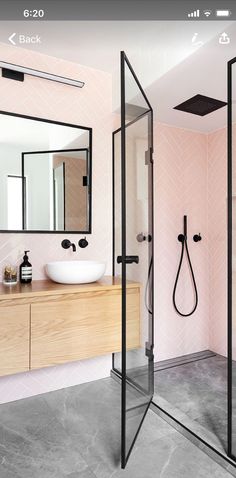 a bathroom with pink walls and black fixtures