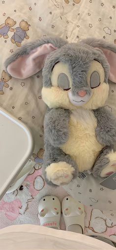 a stuffed rabbit sitting on top of a bed