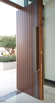 an open wooden door with glass on the outside