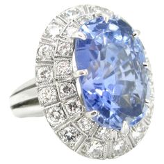 Weight: 17.62gr Metal: Platinum Stones: 1 Sapphire • Cut: Cushion • Carat: 20ct approximately • Origin: Ceylon No Heat Others: 32 Diamonds • Cut: Brilliant • Total Carat Weight: 2ct approximately • Colour: G/H • Clarity: VS Condition: Very Good Hallmarks: French – dog’s head Comments: This beautiful ring is set with a 20ct Ceylon No heat sapphire. The sapphire is surrounded with 32 brilliant cut diamonds for a total carat weight of 2ct approximately. There is a refined millegrain setting. The ri Classic Sapphire Ring With 17 Jewels In Platinum, Collectible Oval Sapphire Ring In Platinum, Classic Platinum Sapphire Ring, Vintage Gia Certified Sapphire Ring For Formal Occasions, French Dog, Golden Ring, Big Rings, No Heat, Diamond Cluster Ring