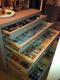 the drawers are filled with jewelry and bracelets